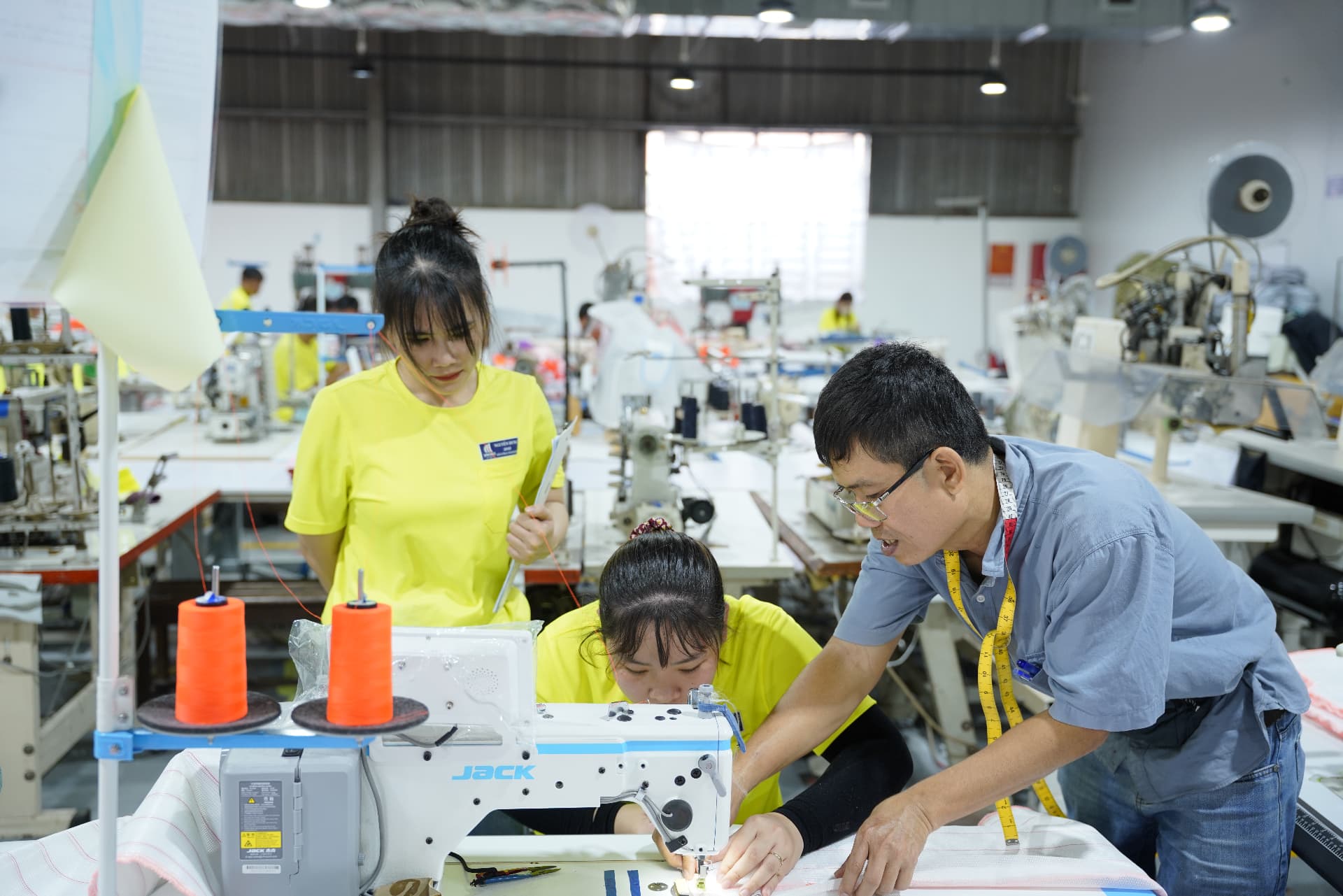 Viking Rubber Co. production team reviewing a garment at the sewing line
